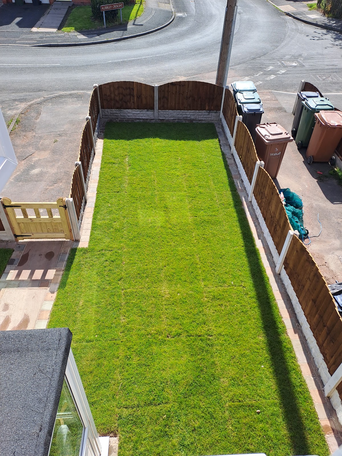 Finished garden transformation with new turf, scalloped featheredge fencing and a timber gate
